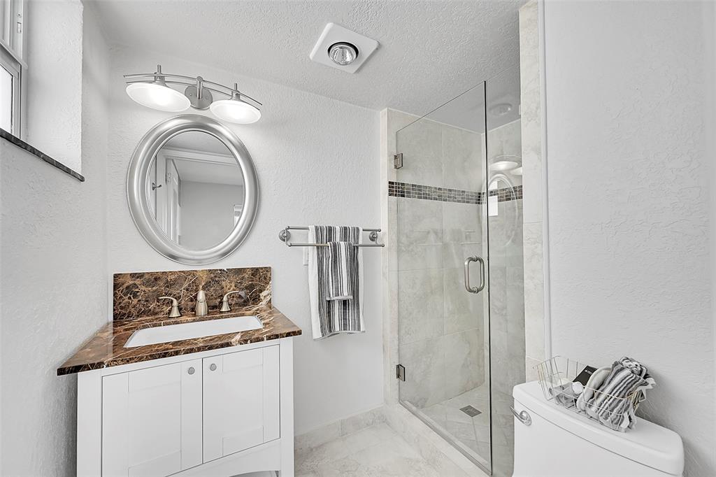 1530 South Ocean Boulevard, Unit 12 Lauderdale-by-the-Sea, FL 33062 - Photo 23 of 81 a bathroom with a sink a mirror and a shower