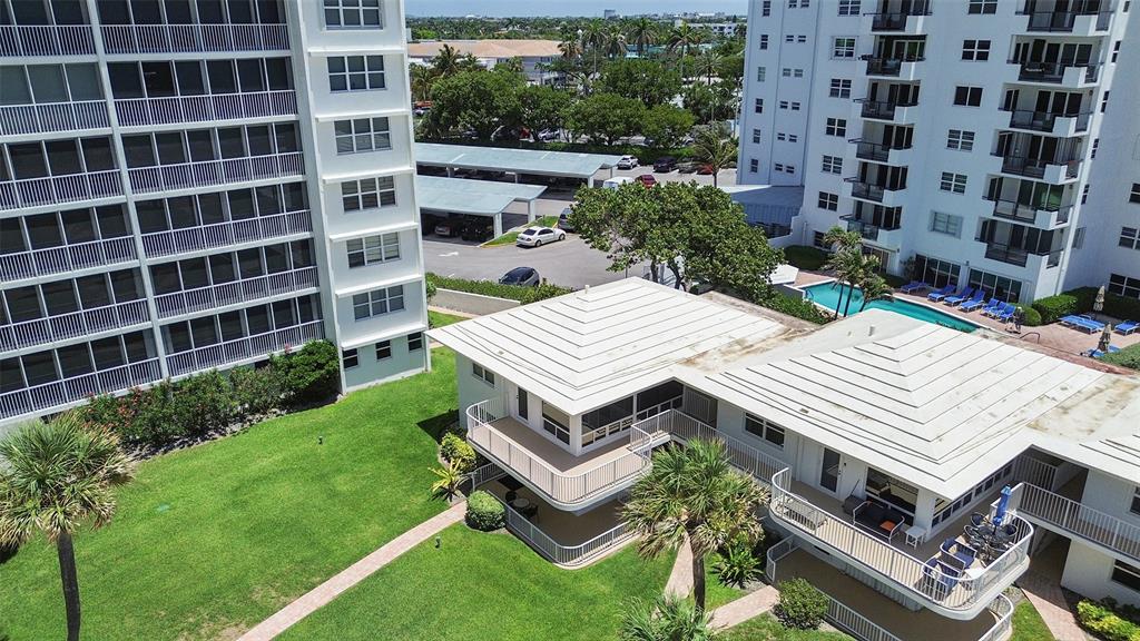 1530 South Ocean Boulevard, Unit 12 Lauderdale-by-the-Sea, FL 33062 - Photo 46 of 81 a view of a patio with a table and chairs and potted plants