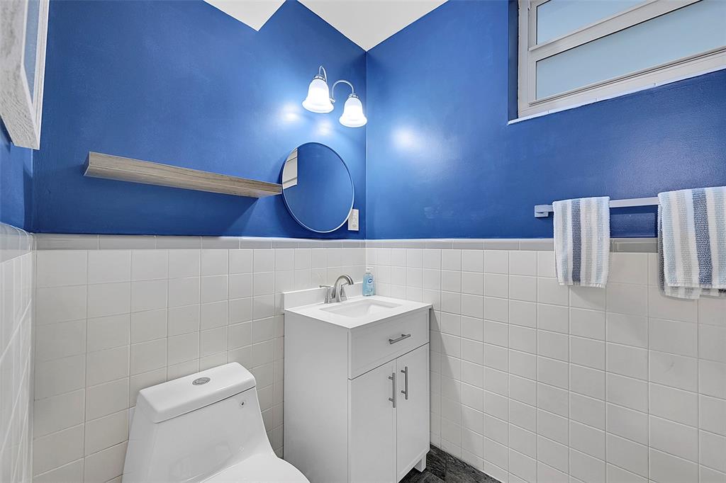 1530 South Ocean Boulevard, Unit 12 Lauderdale-by-the-Sea, FL 33062 - Photo 80 of 81 a bathroom with a sink a toilet and a mirror