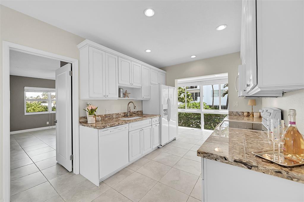 1530 South Ocean Boulevard, Unit 12 Lauderdale-by-the-Sea, FL 33062 - Photo 10 of 81 a kitchen with stainless steel appliances granite countertop a stove and a sink