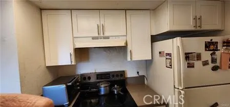 a kitchen with appliances and cabinets