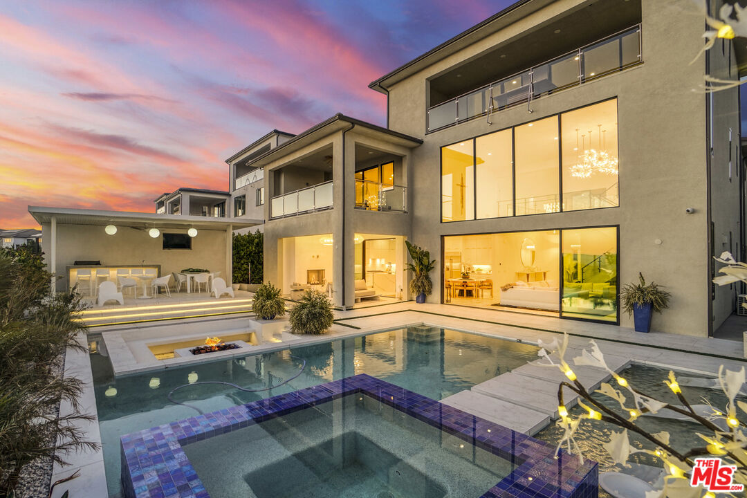a swimming pool view with a seating space