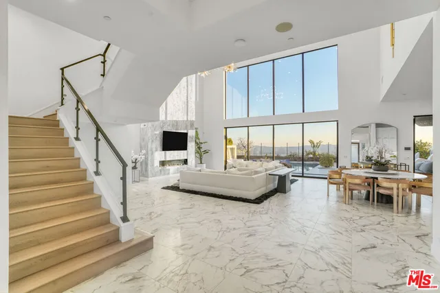 a kitchen with stainless steel appliances kitchen island granite countertop a table and chairs in it