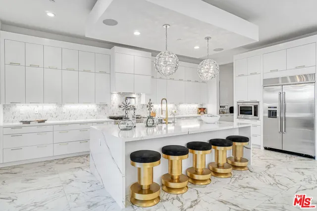 a dining room with furniture a large window and potted plants