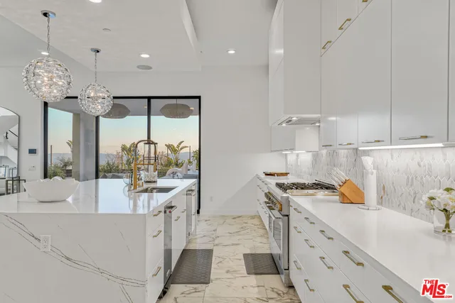 a living room with fireplace furniture and a chandelier
