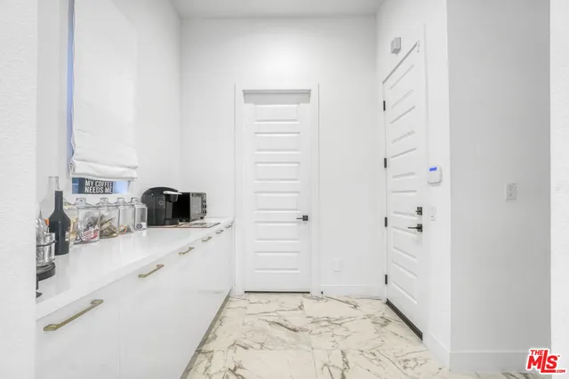 a living room with furniture or kitchen view and a chandelier