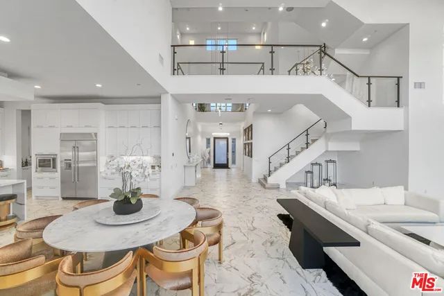 a spacious bedroom with a large bed and a large window