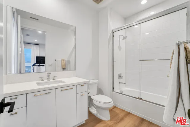 a bedroom with a bed and a potted plant