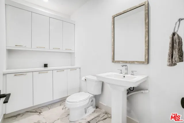 a bedroom with a bed potted plant and a potted plant