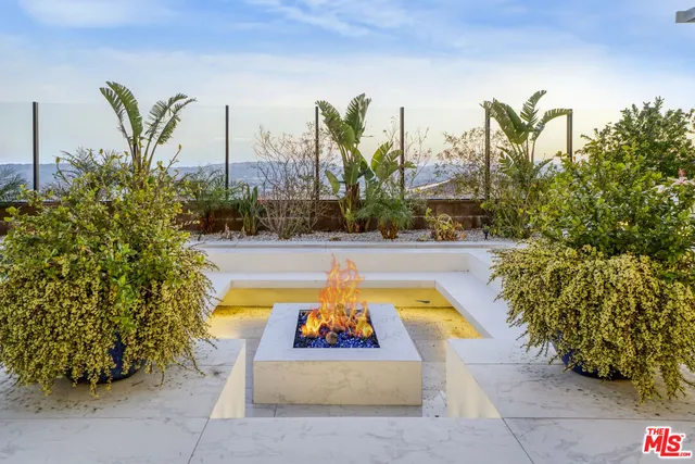 a balcony with furniture and a floor to ceiling window
