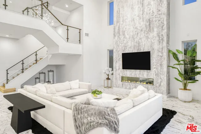 a living room with furniture and a large mirror