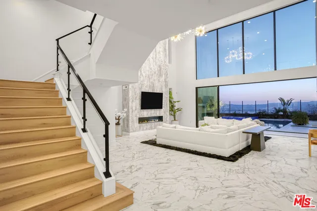 a large room with a bed and a chandelier