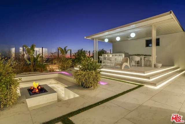 a view of a balcony with furniture and a flat screen tv