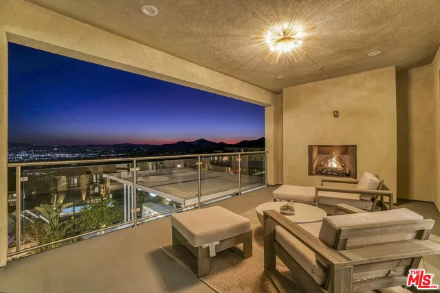 a living room with furniture fireplace and a large window