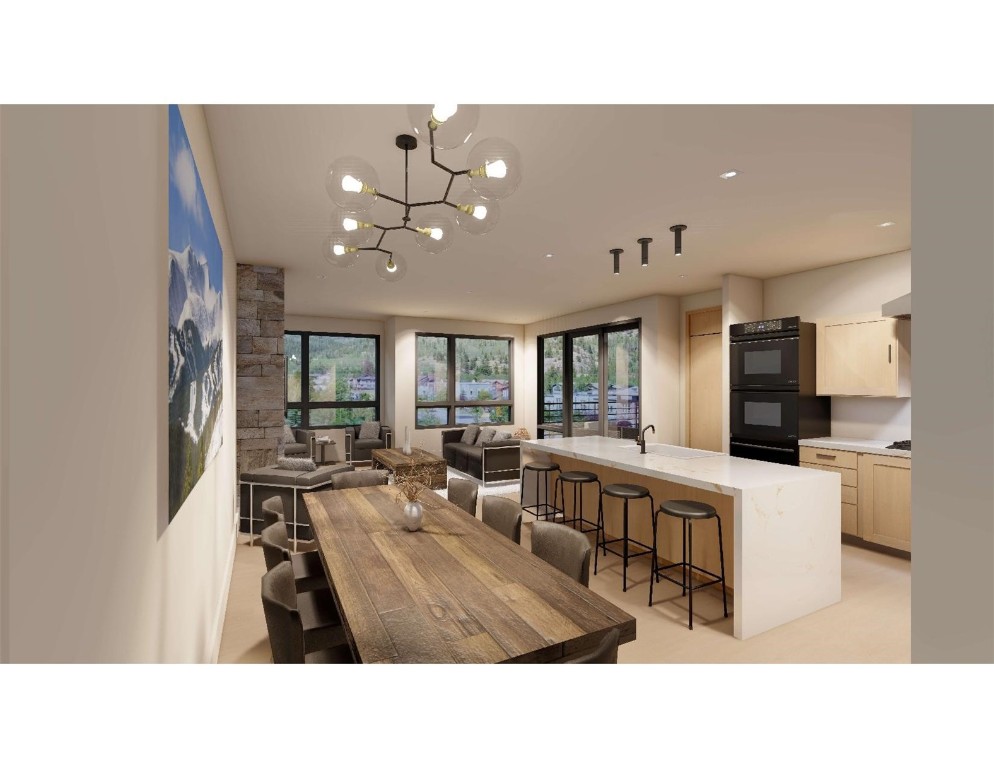 a living room with stainless steel appliances kitchen island granite countertop a table chairs and a refrigerator