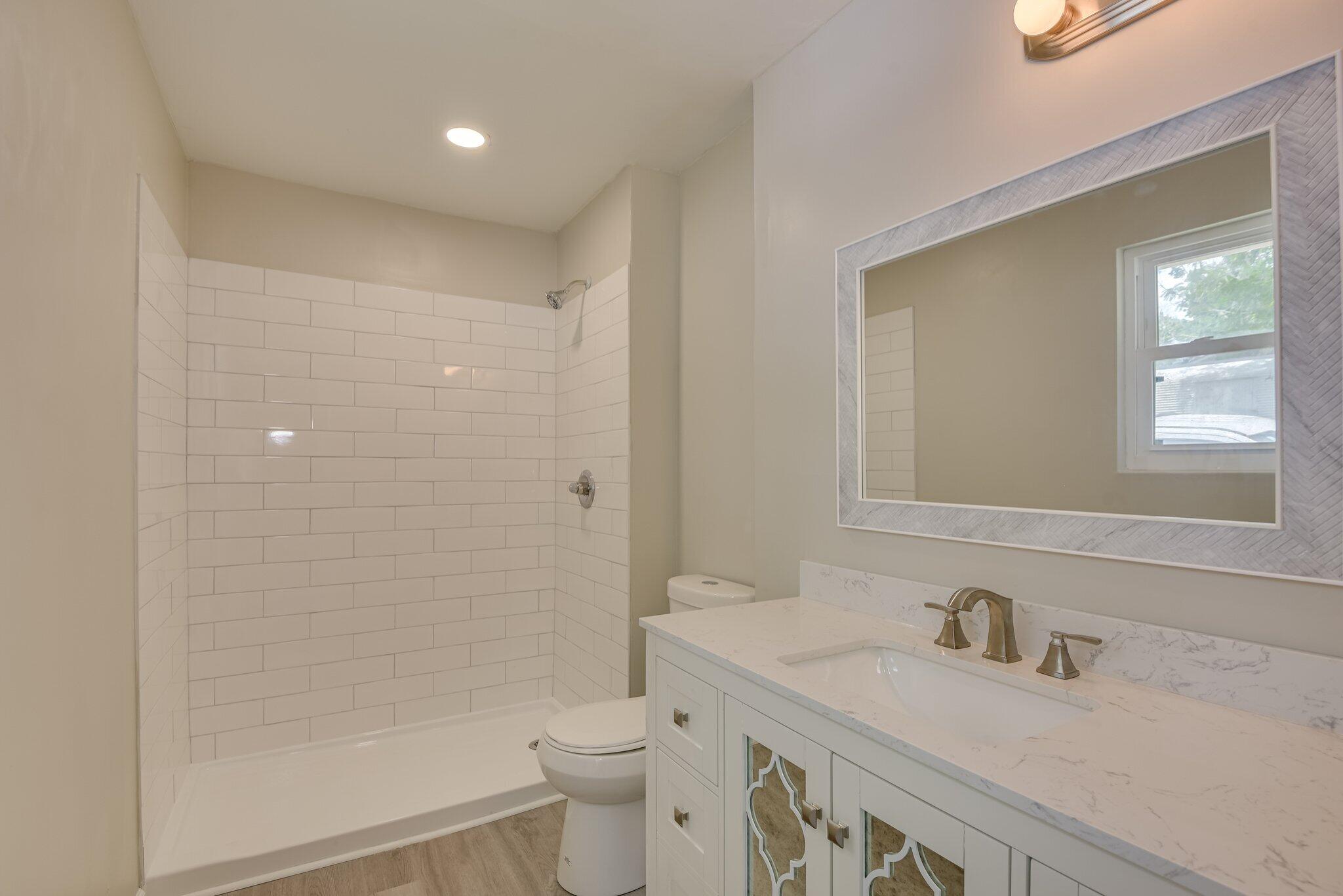 2115 Ashley Drive Augusta, GA 30906 - Photo 26 of 38 a bathroom with a granite countertop sink a toilet and shower