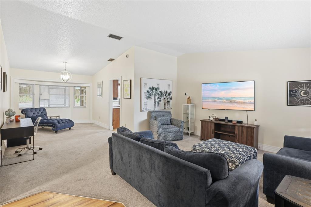 244 Angeles Road DeBary, FL 32713 - Photo 8 of 41 a living room with furniture and a flat screen tv