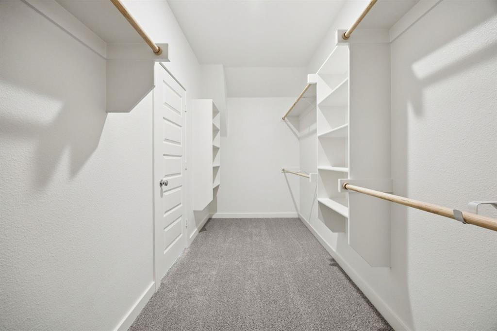 5721 Rushing River Way McKinney, TX 75071 - Photo 21 of 29 Primary Closet in the Heisman home plan by Trophy Signature Homes – REPRESENTATIVE PHOTO