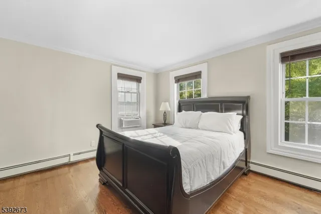 a bedroom with a bed and windows