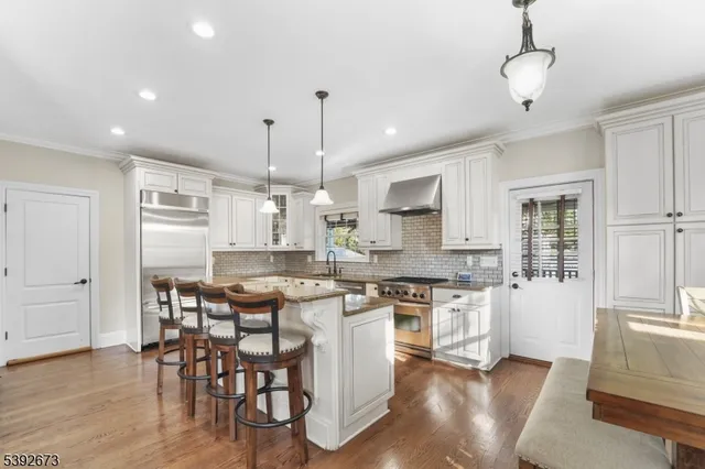 a large kitchen with a table and chairs