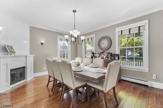 a view of a dining room with furniture a chandelier and wooden floor