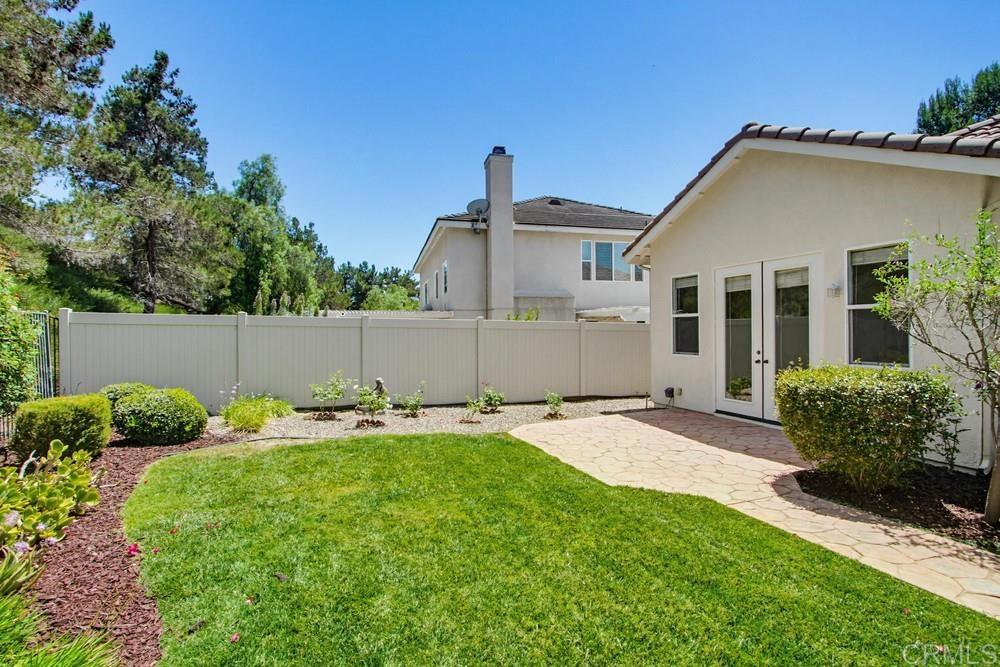 672 Inverlochy Drive Fallbrook, CA 92028 - Photo 62 of 75 a backyard of a house with table and chairs