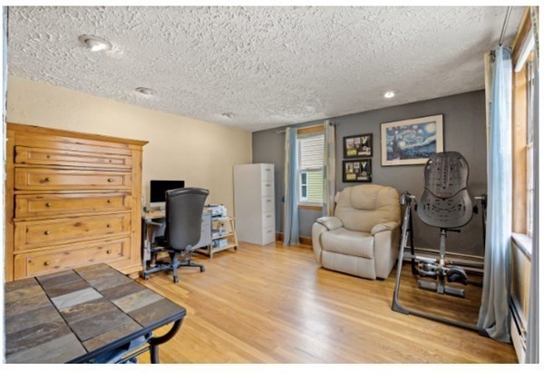 15 Oak Road Medford, MA 02155 - Photo 11 of 18 a living room with furniture and a flat screen tv