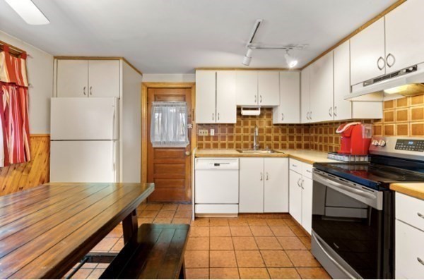 15 Oak Road Medford, MA 02155 - Photo 6 of 18 a kitchen with a sink cabinets and wooden floor