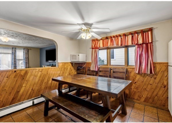 15 Oak Road Medford, MA 02155 - Photo 7 of 18 a living room with a dining table chairs and a chandelier