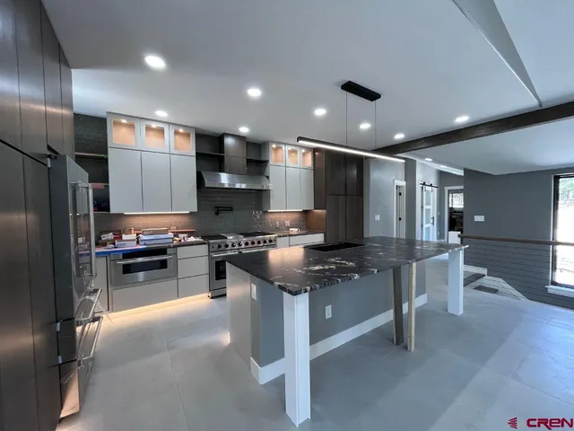 an empty room with windows and view of balcony