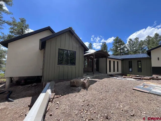 a front view of a house with a yard outdoor seating and garage