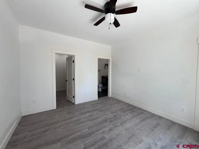 a view of a room with wooden floor and iron stairs