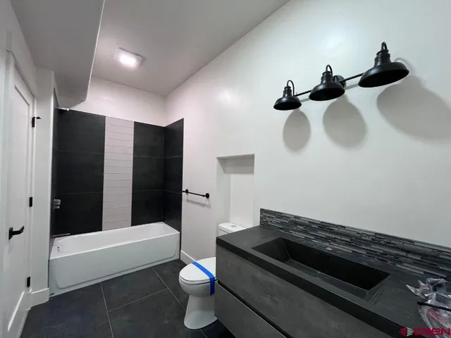 a view of a street with a large tree