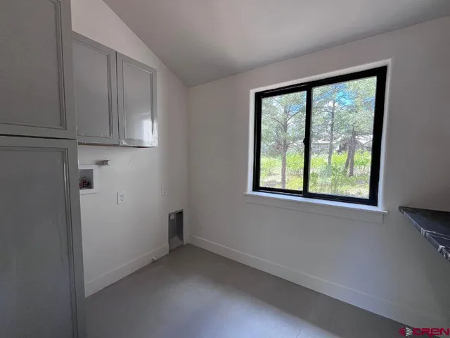a view of a kitchen with stove and cabinets
