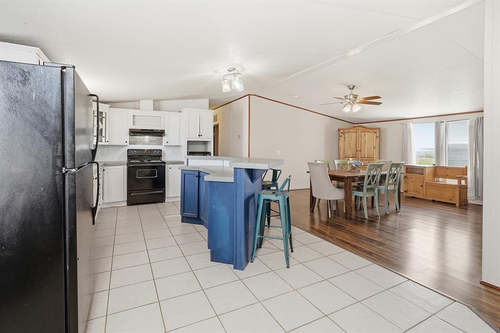 2538 County Road 2320 Decatur, TX 76234 - Photo 11 of 40 a open kitchen with stainless steel appliances granite countertop a refrigerator dining table and chairs