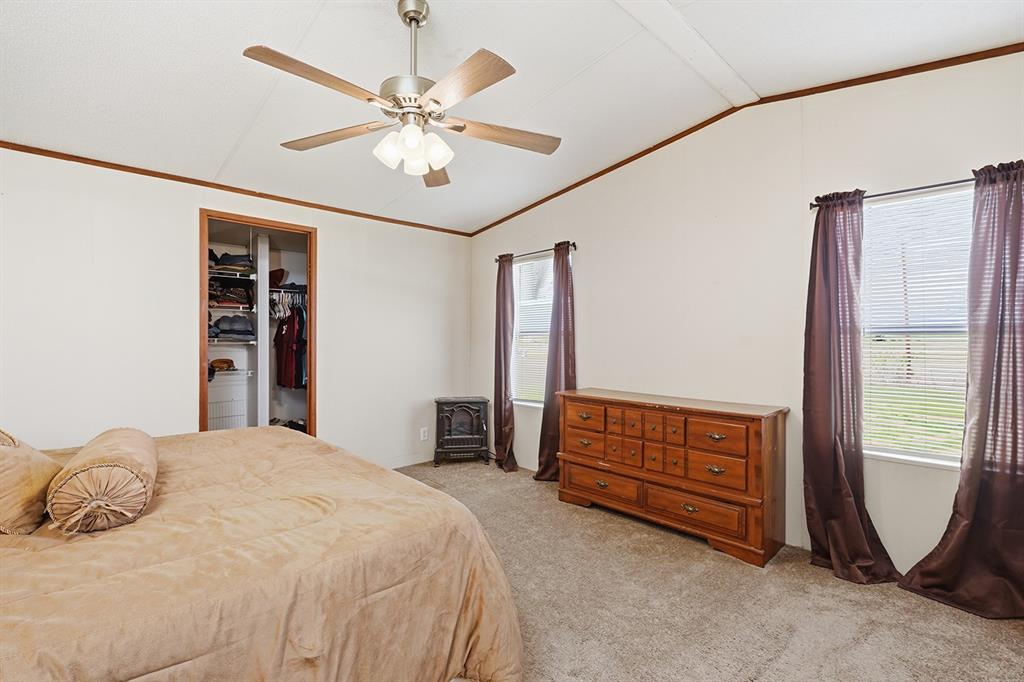 2538 County Road 2320 Decatur, TX 76234 - Photo 19 of 40 a bedroom with a bed and a chandelier