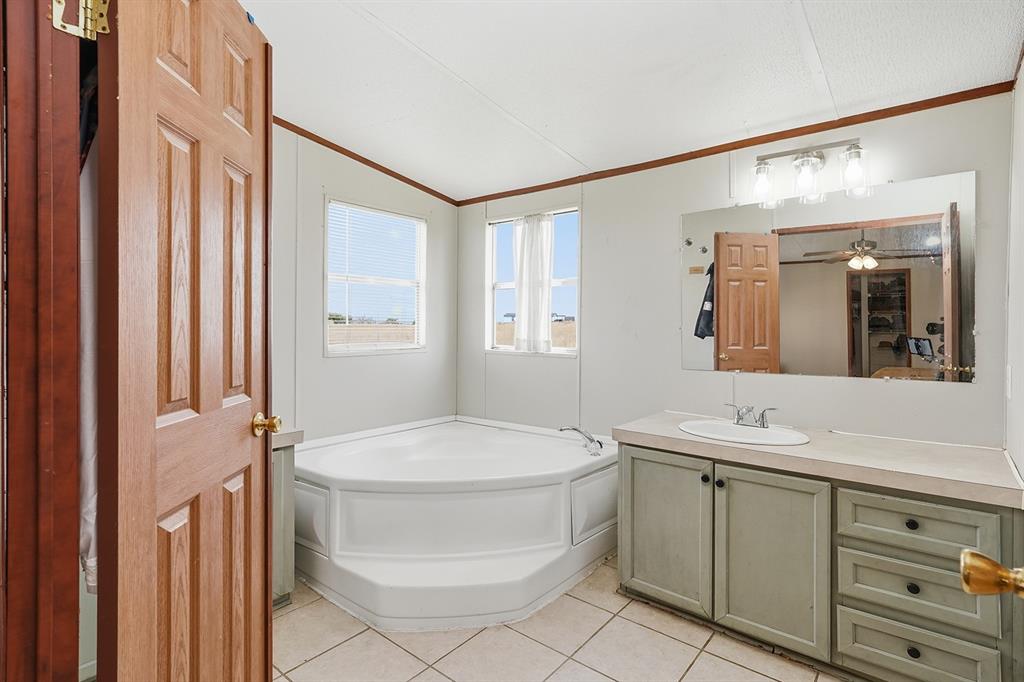 2538 County Road 2320 Decatur, TX 76234 - Photo 20 of 40 a bathroom with a sink toilet and shower