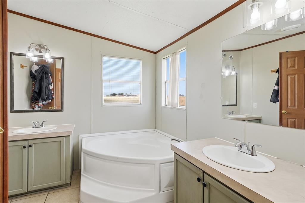 2538 County Road 2320 Decatur, TX 76234 - Photo 21 of 40 a bathroom with a sink and a mirror
