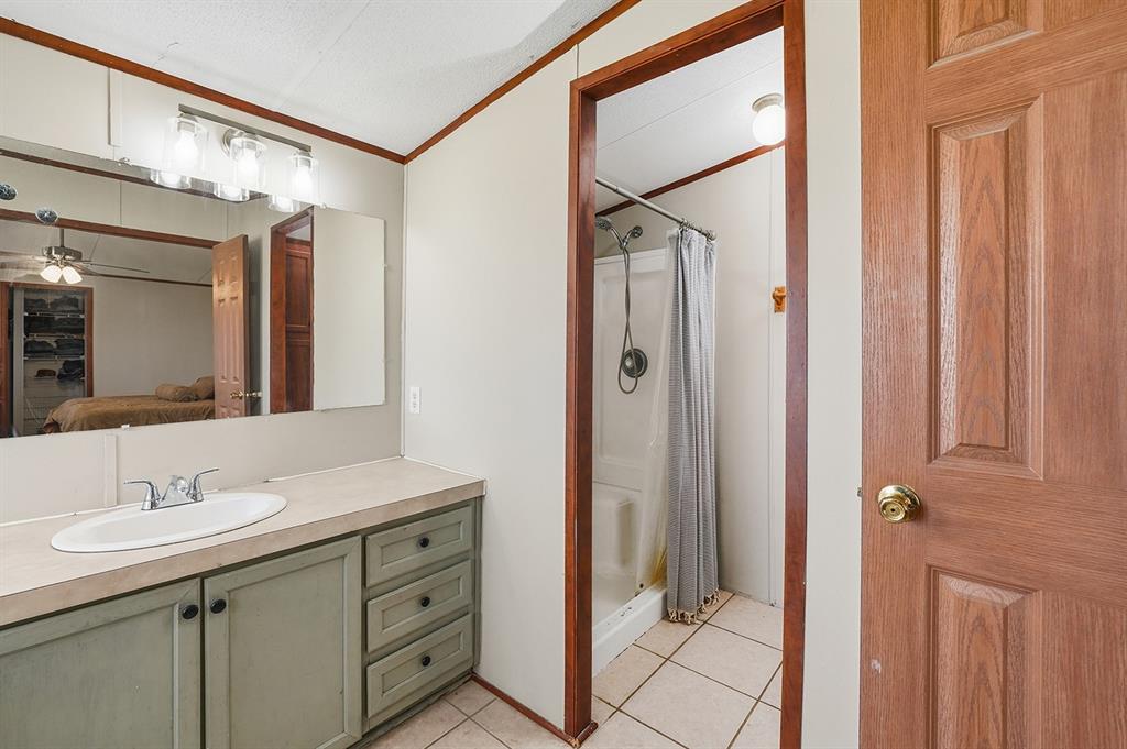 2538 County Road 2320 Decatur, TX 76234 - Photo 22 of 40 a bathroom with a double vanity sink and mirror