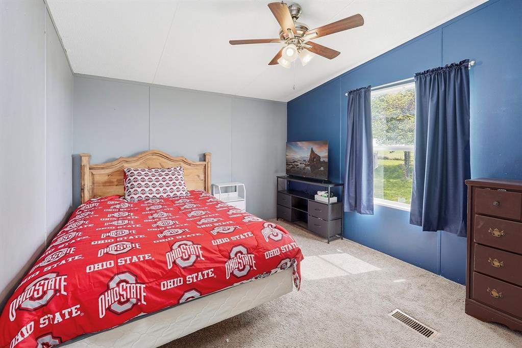 2538 County Road 2320 Decatur, TX 76234 - Photo 23 of 40 a bedroom with a bed and a tv on dresser