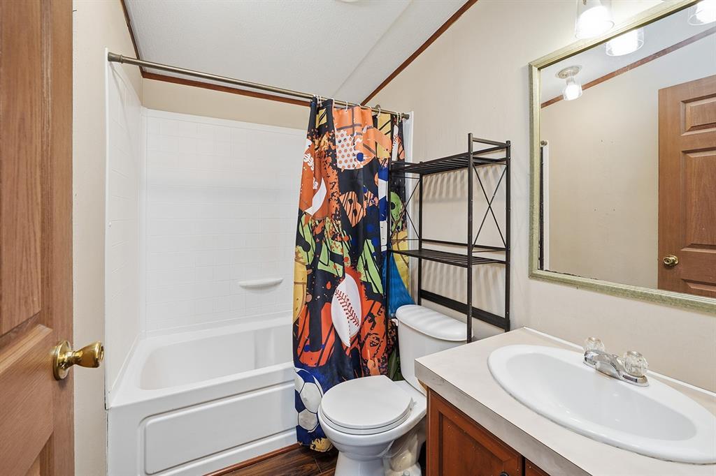 2538 County Road 2320 Decatur, TX 76234 - Photo 27 of 40 a bathroom with a sink toilet and shower