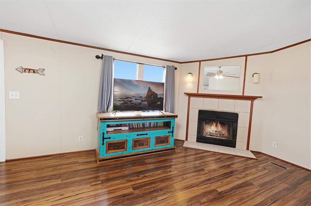 2538 County Road 2320 Decatur, TX 76234 - Photo 6 of 40 a living room with a fireplace a flat screen tv and a fireplace