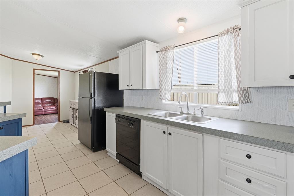 2538 County Road 2320 Decatur, TX 76234 - Photo 8 of 40 a kitchen with a sink appliances and cabinets