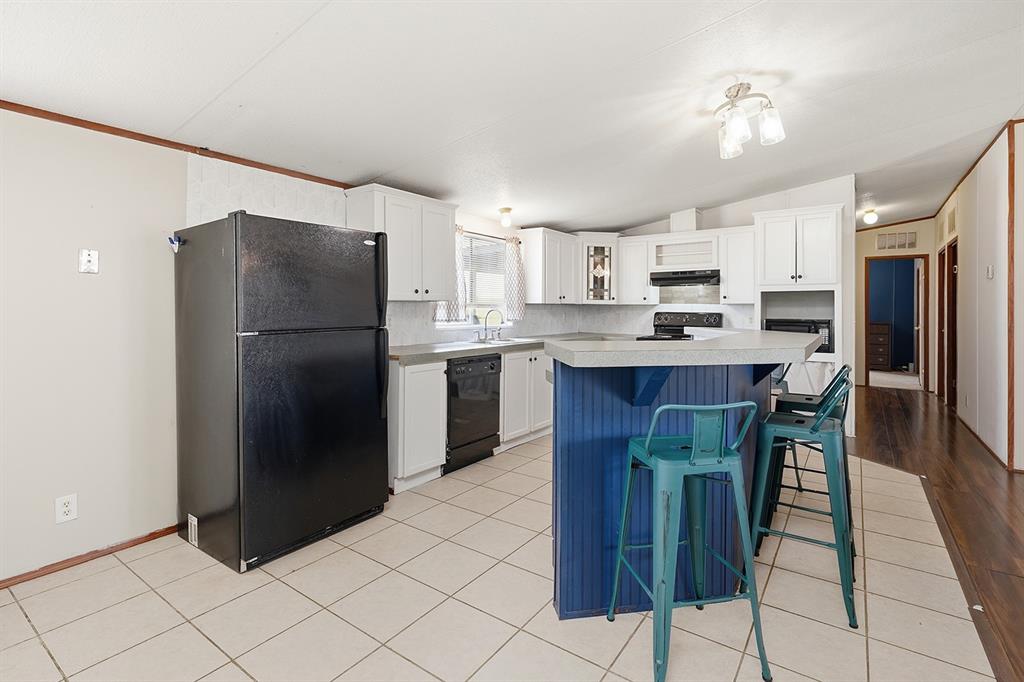 2538 County Road 2320 Decatur, TX 76234 - Photo 10 of 40 a kitchen with stainless steel appliances a refrigerator and a stove top oven