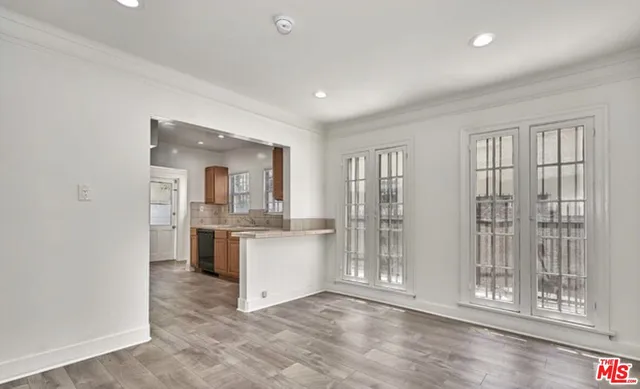 a living room with stainless steel appliances granite countertop furniture and a kitchen view