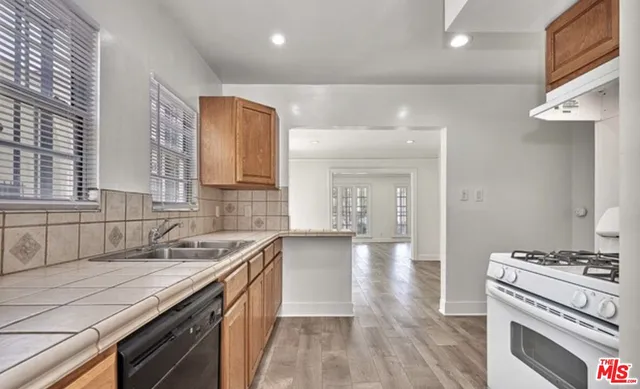 a kitchen with a sink stove and cabinets