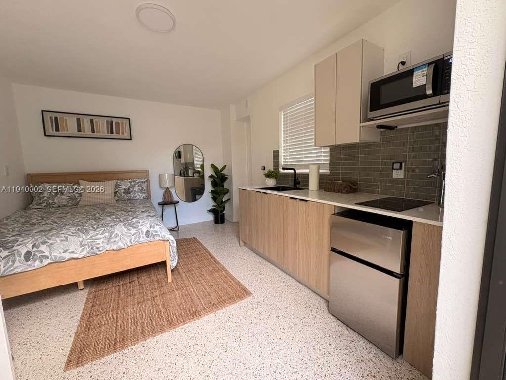 2442 Southwest 3rd Street, Unit 4 Miami, FL 33135 - Photo 3 of 13 a bedroom with a bed and a view of living room