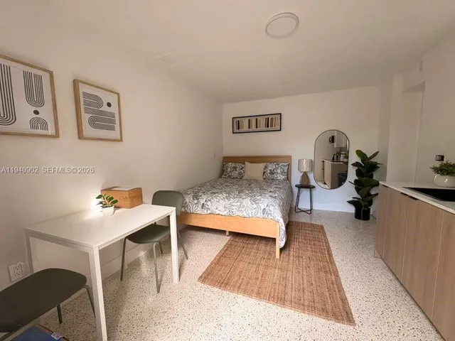a bedroom with furniture and a wooden floor