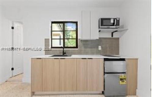 2442 Southwest 3rd Street, Unit 4 Miami, FL 33135 - Photo 6 of 13 a kitchen with stainless steel appliances granite countertop a sink and a granite counter tops