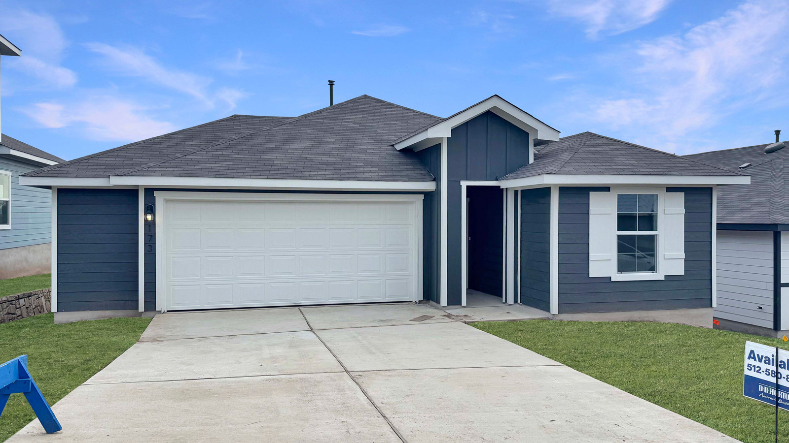 173 Balmorhea Street Kyle, TX 78640 - Photo 1 of 2 a front view of a house with a garden and yard
